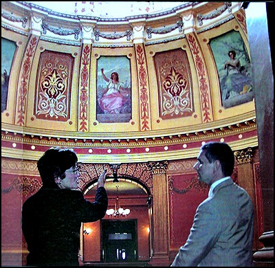 Historians Kerry Chartkoff and Geoffrey Drutchas examine rotunda muses painted by Juglaris in 1886