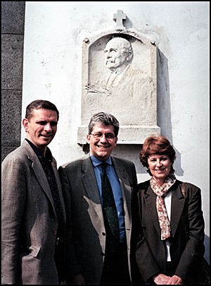 Geoffrey Drutchas, Domenico Giacotto, and Judith Hochwald Trinchero beneath Juglaris bas relief